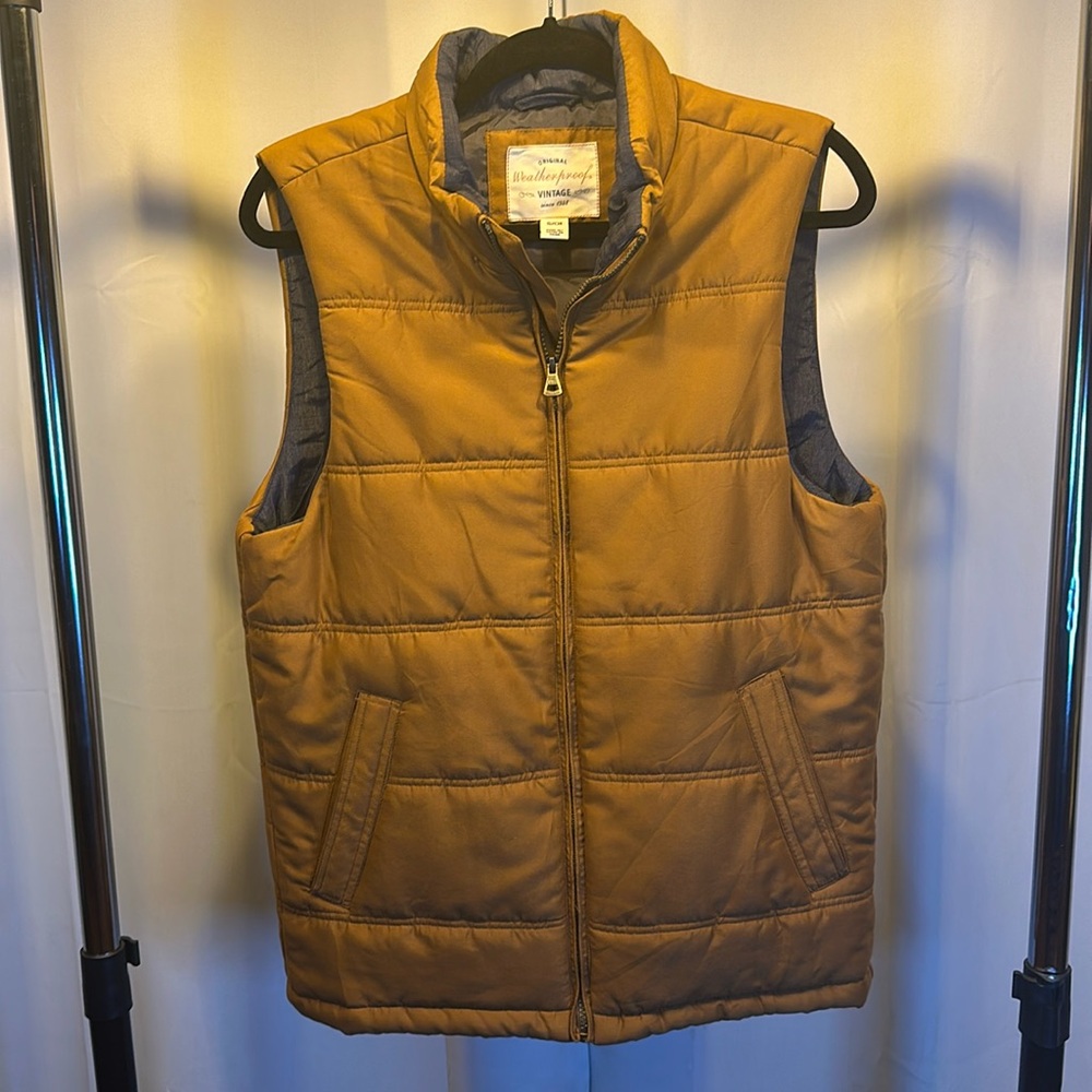 Men’s small tan vest with a blue inner liner